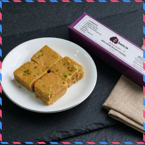 Bazic sattu barfi Bikaneri besan chakki pieces on a white plate with gold packaging