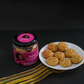 Flat lay of Bazic mini jowar cookies with jar on a neutral background