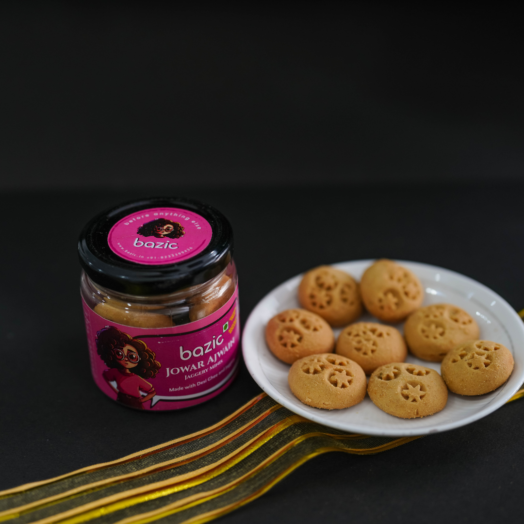 Flat lay of Bazic mini jowar cookies with jar on a neutral background