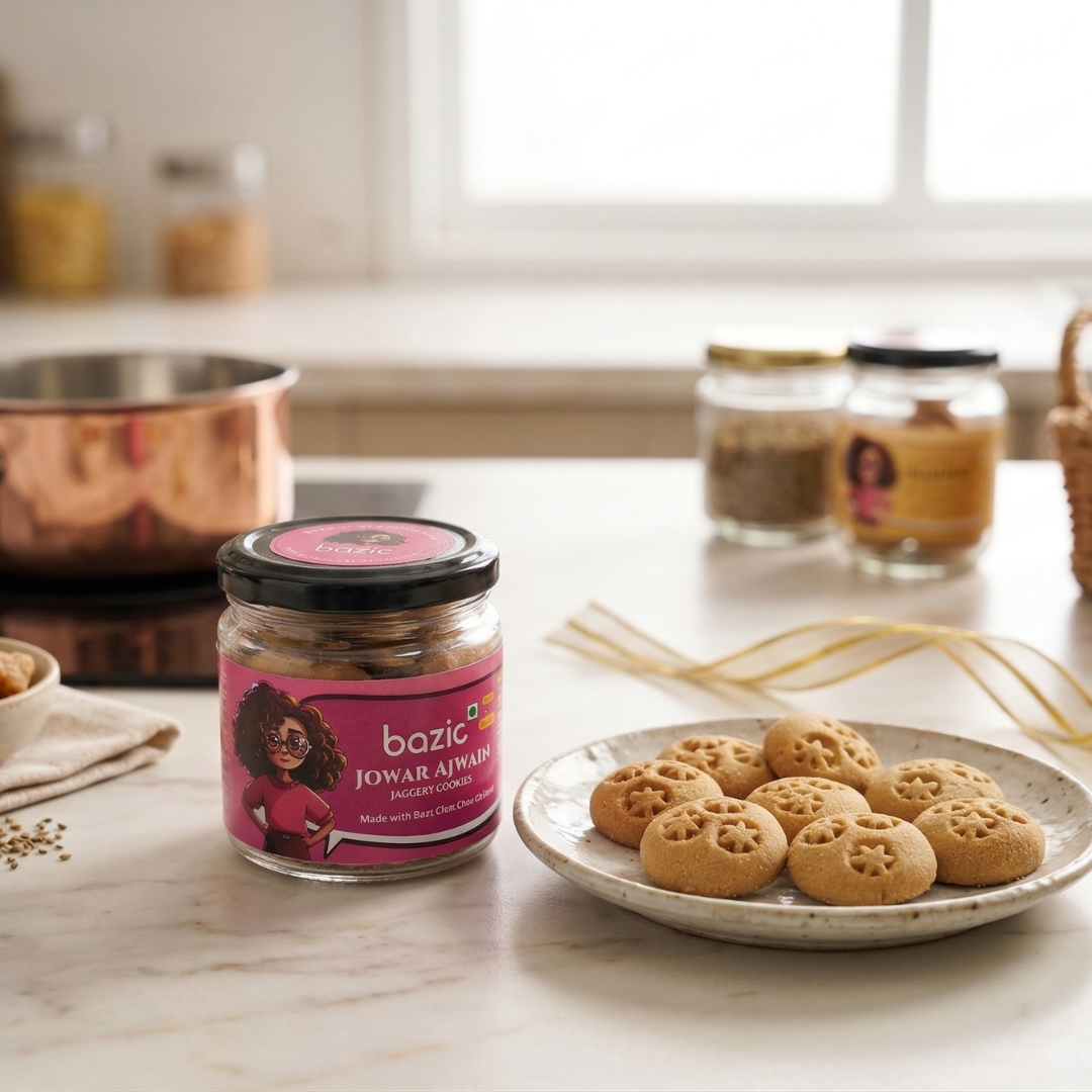 Open glass jar of Bazic mini ajwain jaggery jowar cookies on a light surface
