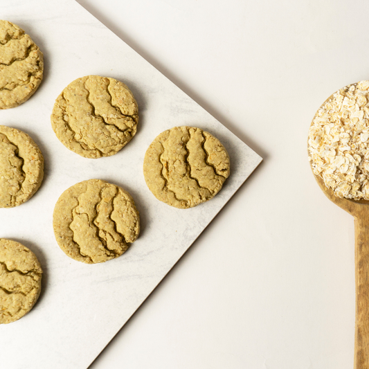 Bazic oats bajra butter cookies in open box showing 5 individual pouches of 2 cookies each